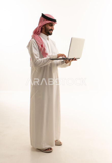 Saudi Man Using Laptop Computer on White Background