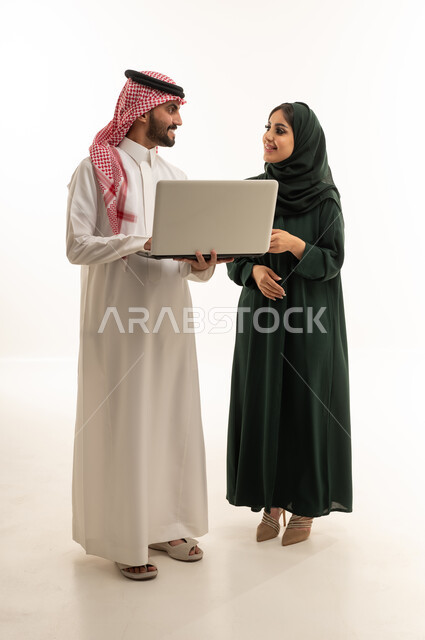 Saudi Man and Woman Working on Laptop in Studio