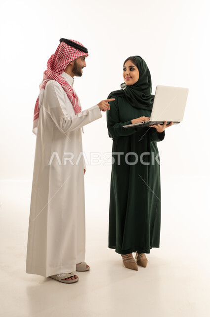 Saudi Professionals Working on Laptop in Studio