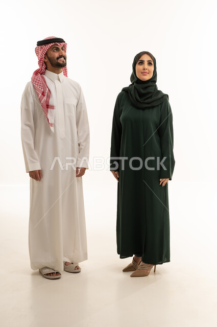 Saudi Man and Woman in Traditional Dress Looking Up