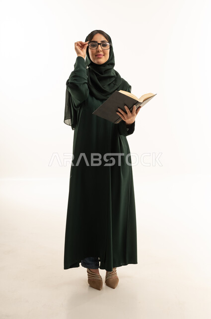 Arab Woman in Green Abaya Holding Book in Studio