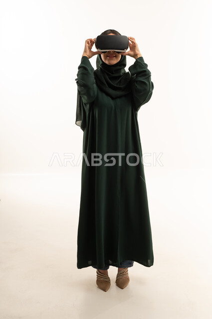 Arab Woman in Abaya Using VR Headset in Studio