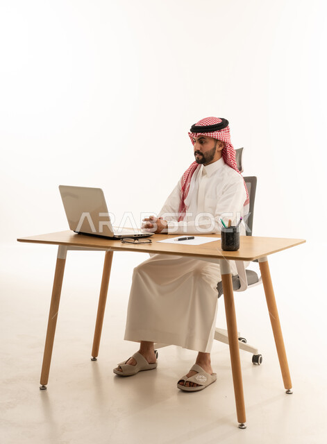 Saudi Businessman at Office Desk with Laptop