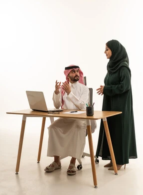 Saudi Business Colleagues Discussing Work in Office