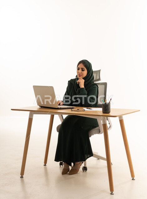 Saudi Businesswoman Working on Laptop White Background