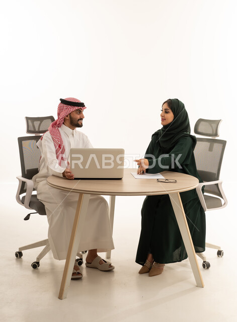 رجل وسيدة أعمال سعوديين في اجتماع عمل