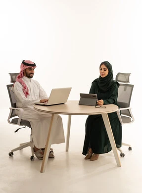 Saudi Business Professionals Working on Laptop and Tablet