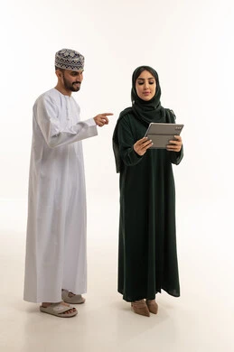 Omani Man and Woman Using Tablet on White Background