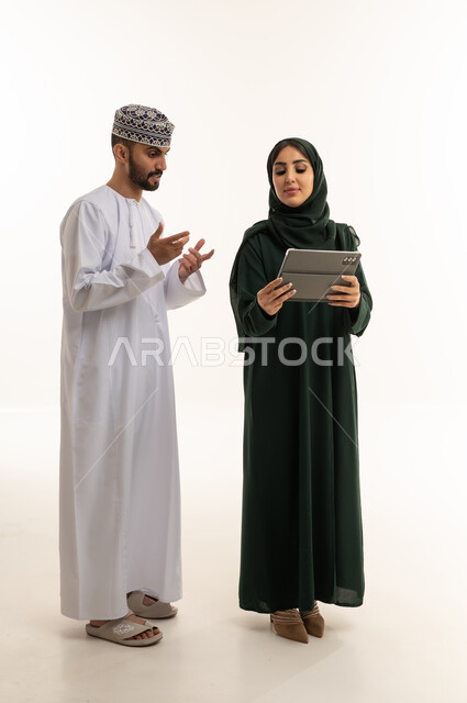 Omani Couple Using Digital Tablet on White Background