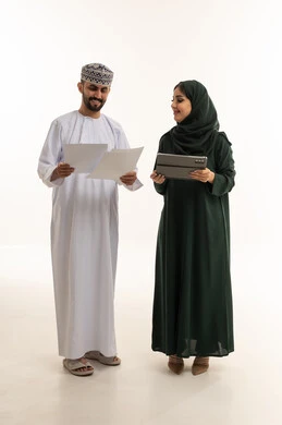 محترفون عمانيون مع جهاز لوحي وأوراق في الاستوديو