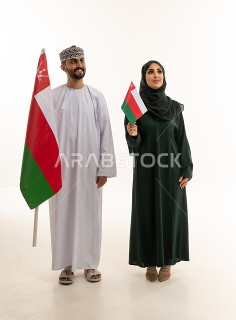 Omani Couple Holding National Flag in Studio