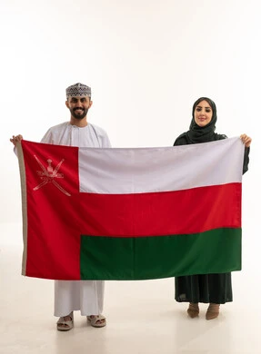 Omani Man and Woman Holding Oman National Flag in Studio