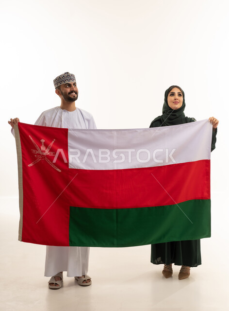 Omani Man and Woman Holding Oman National Flag