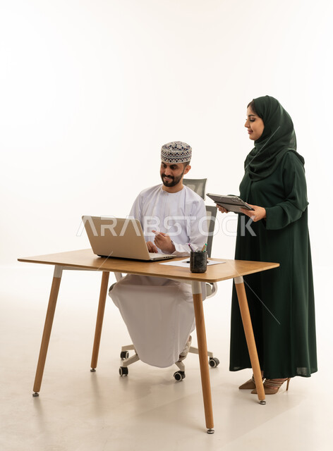 Omani Business Colleagues Working Together in Studio
