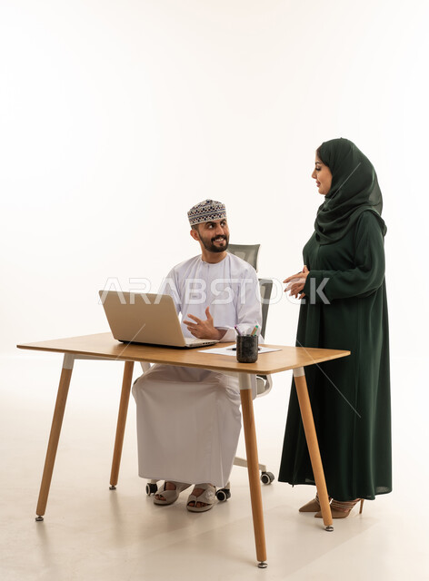 Omani Businessman and Colleague Working in White Studio