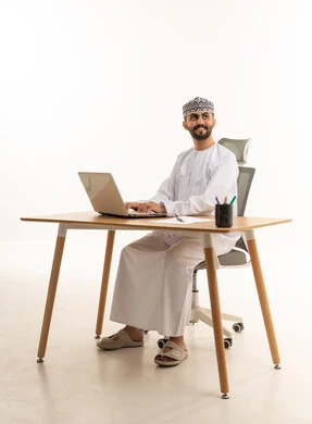 Omani Man Working on Laptop in Studio Office