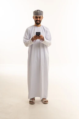 Omani Man in Traditional Dress Using Smartphone