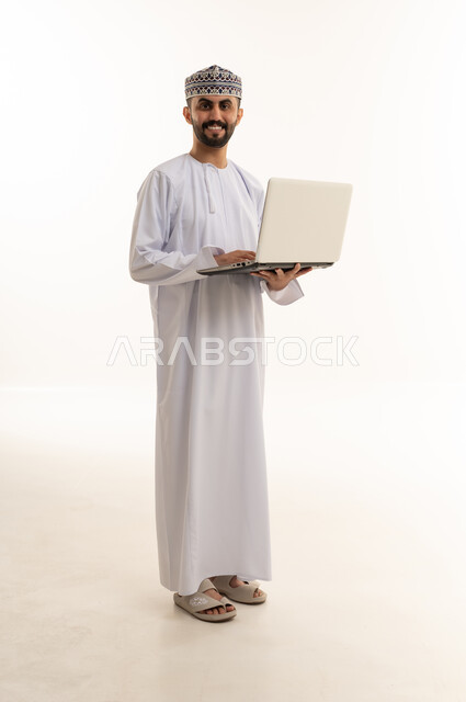 Omani Man in Traditional Dress with Laptop