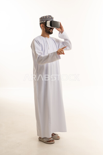 Omani Man Using VR Headset on White Studio Background