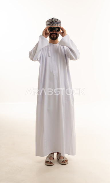 Omani Man in Traditional Dress Using Binoculars
