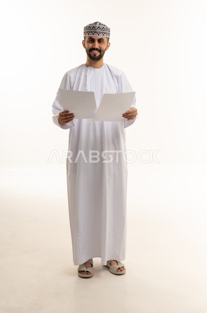 Omani Man Holding Documents in Traditional Dress