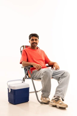 Saudi Man Sitting on Camping Chair with Cooler Box Studio