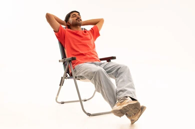 Saudi Man Relaxing in Camping Chair on White Background
