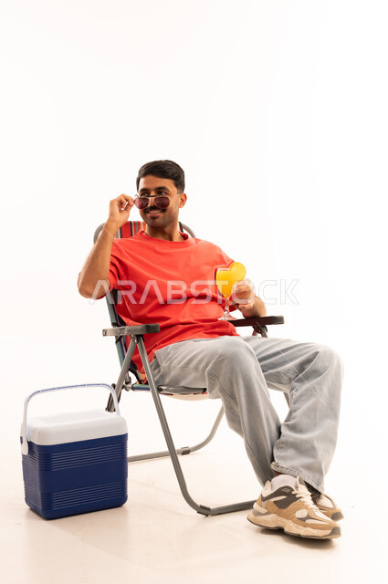 Saudi Man on Camping Chair with Cooler and Juice