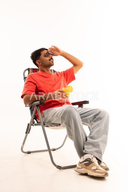 Saudi Man on Beach Chair with Juice White Background