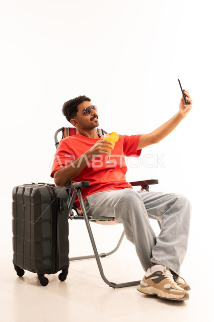 Saudi Traveler Taking Selfie with Suitcase and Juice