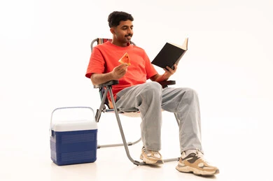Saudi Man Reading on Camping Chair in Studio
