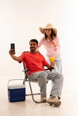 Arab Couple Taking Selfie with Summer Gear in Studio