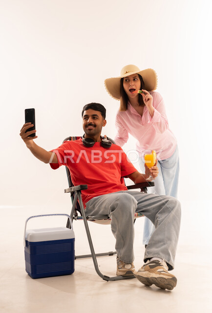 Man Taking Selfie with Woman in Summer Studio Gear