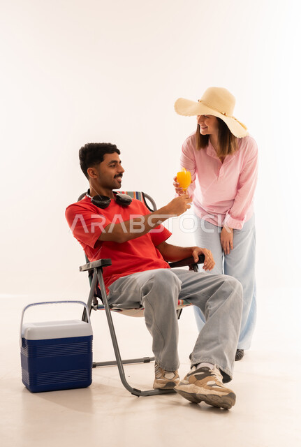 Arab Man and Woman with Camping Gear and Juice