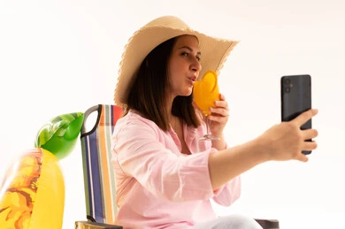 Woman Taking Selfie with Cocktail on Beach Chair