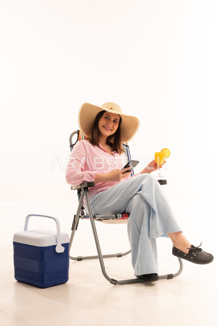 Woman with Juice and Phone in Studio Setting