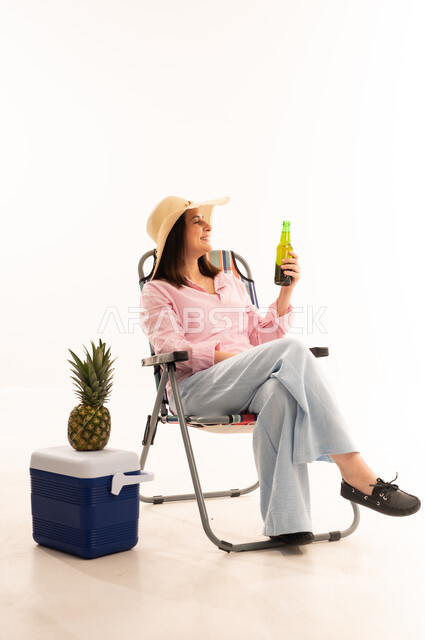 Woman in Camping Chair with Beverage in Studio