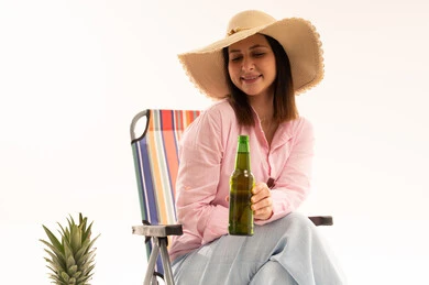 Arab Woman in Sun Hat with Green Bottle