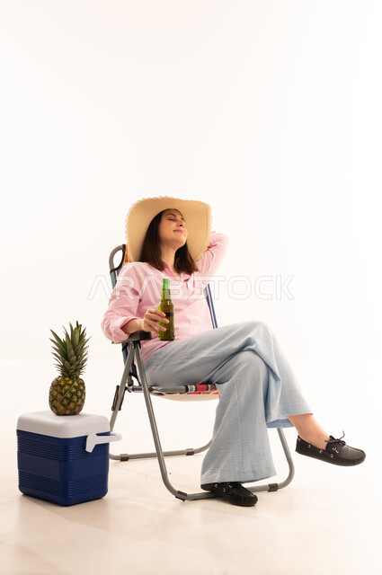 Woman Relaxing in Beach Chair with Cooler and Pineapple
