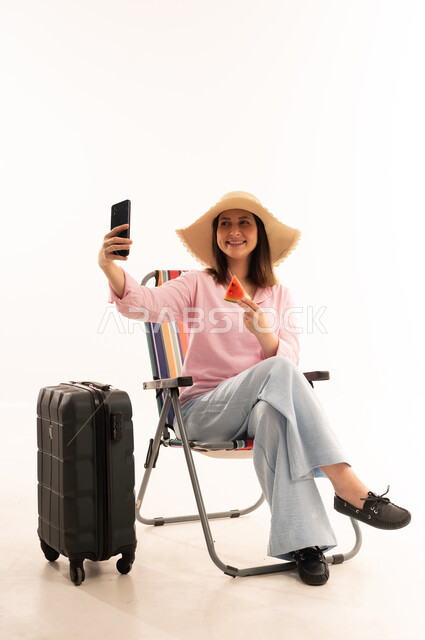 Woman Taking Selfie with Suitcase and Watermelon
