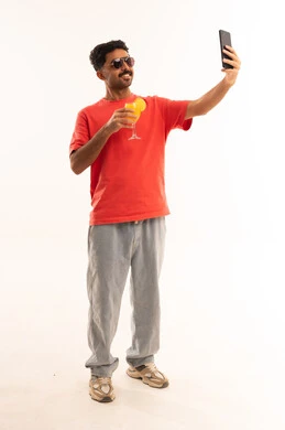 Arab Man Taking Selfie with Orange Juice in Studio