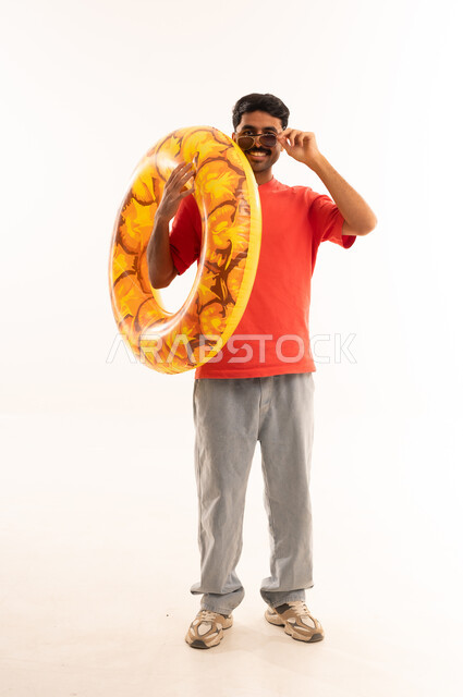 South Asian Man with Inflatable Swim Ring in Studio