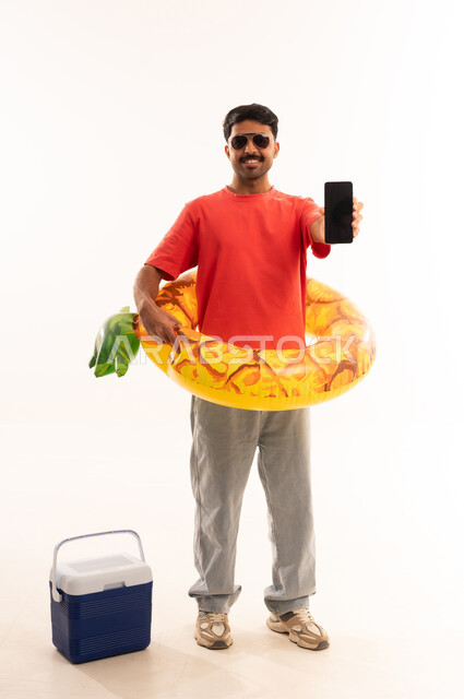 Indian Man with Summer Vacation Gear and Phone