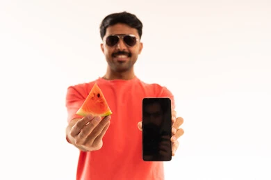 Arab Man Holding Watermelon and Smartphone Studio Shot