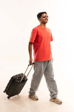 Saudi Man Walking with Suitcase on White Background