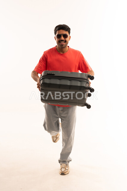 Arab Man Running with Black Suitcase in Studio