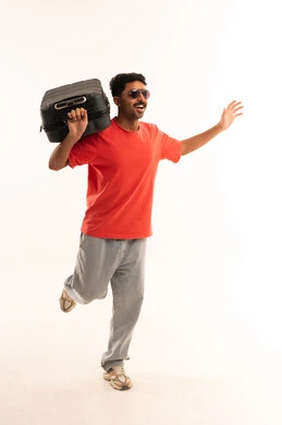 Saudi Man Running with Travel Suitcase in Studio