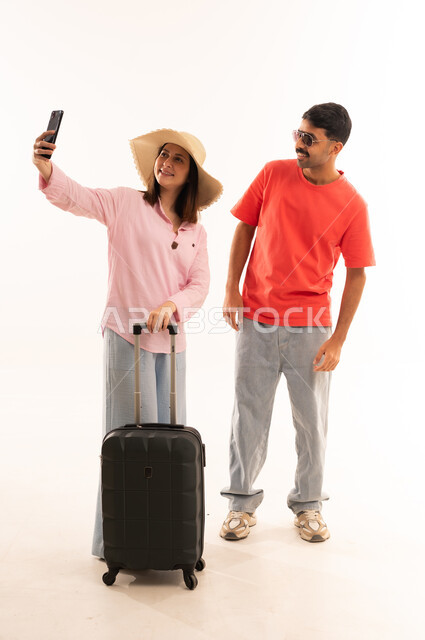 Arab Couple with Suitcase Taking Selfie on White