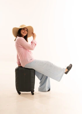 Arab Woman Sitting on Suitcase White Background