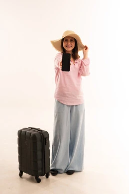 Woman Traveler with Suitcase Holding Smartphone